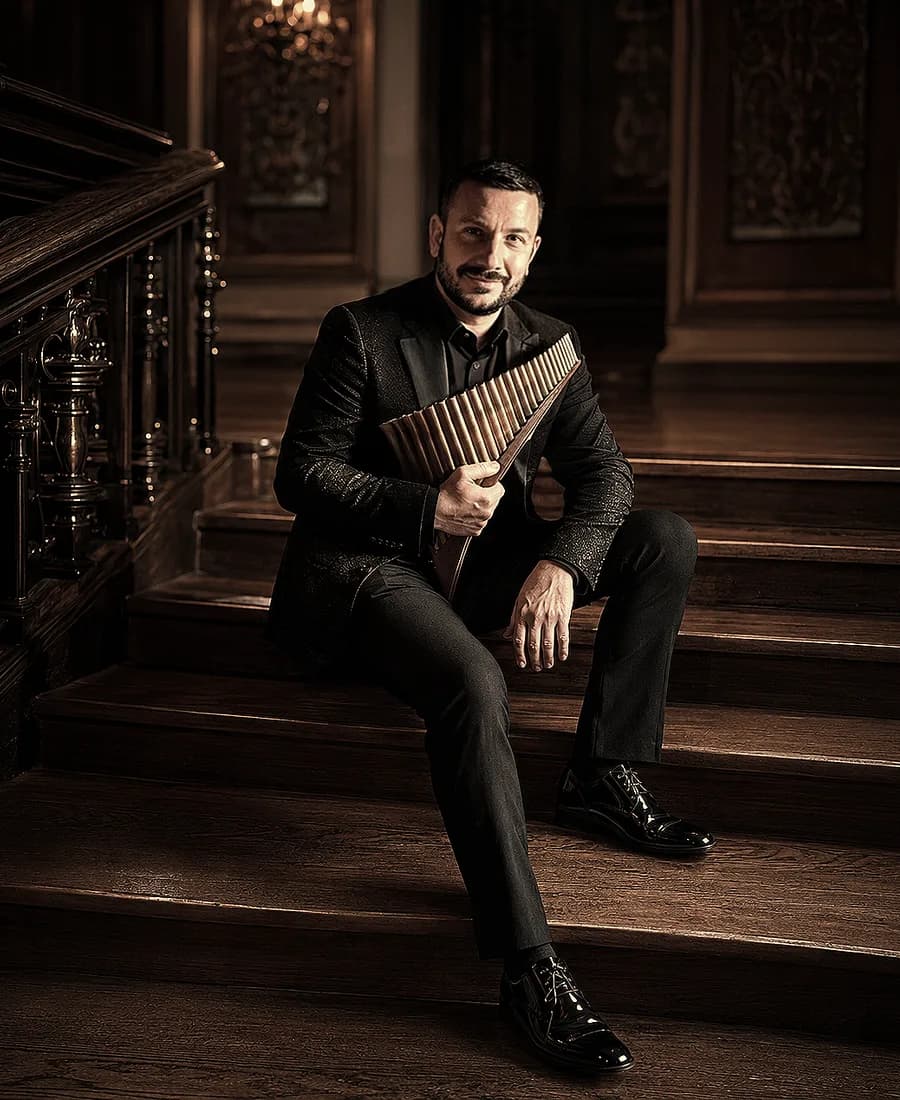 Petr Tomeček in a tailcoat with a glass pan flute